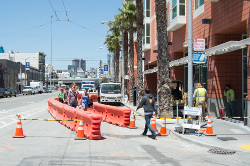 Work to prepare for surface track construction on 4th Street involves locating and moving underground utilities.